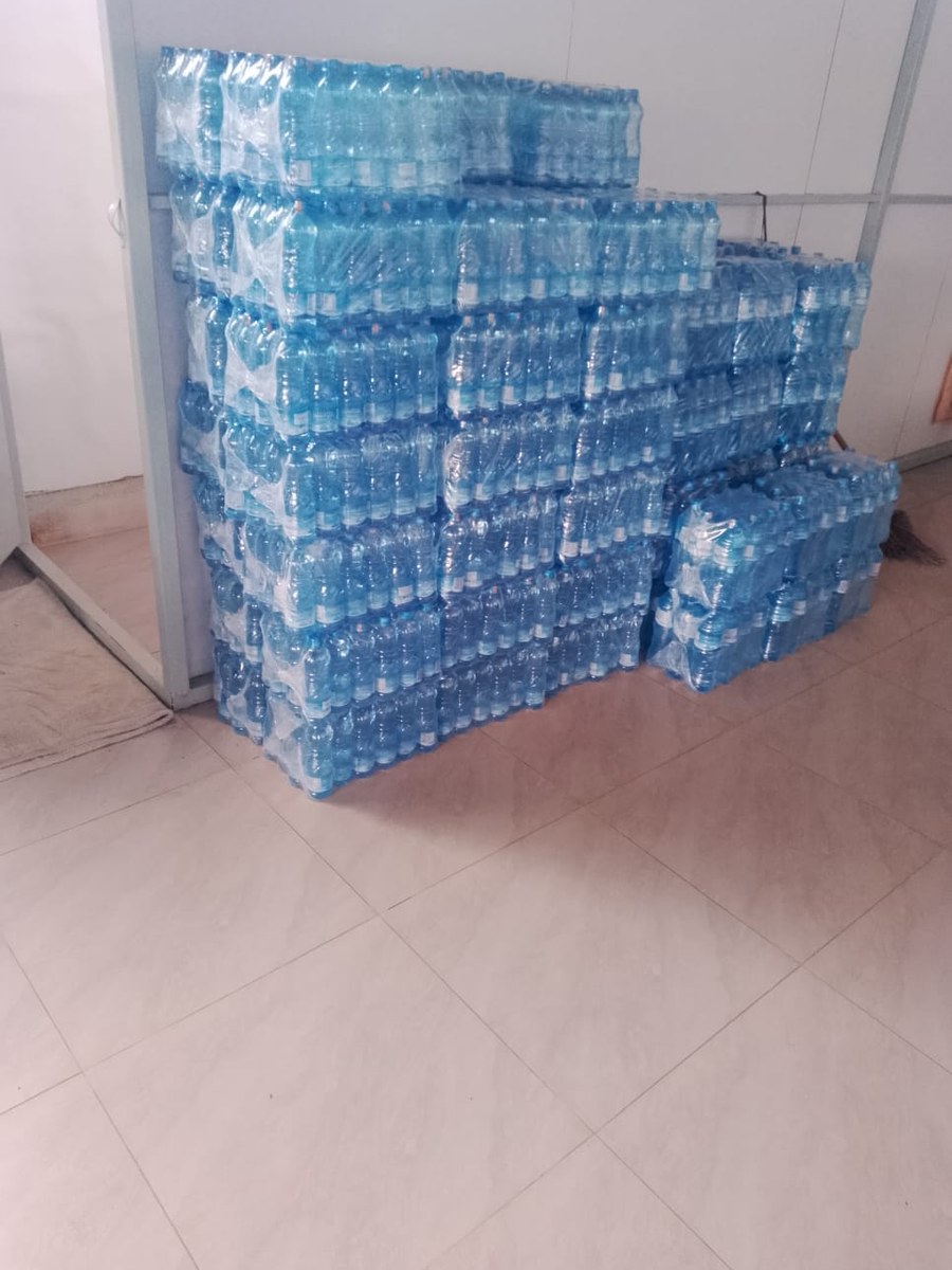 Palletised cases of Mamstar bottled water in the warehouse